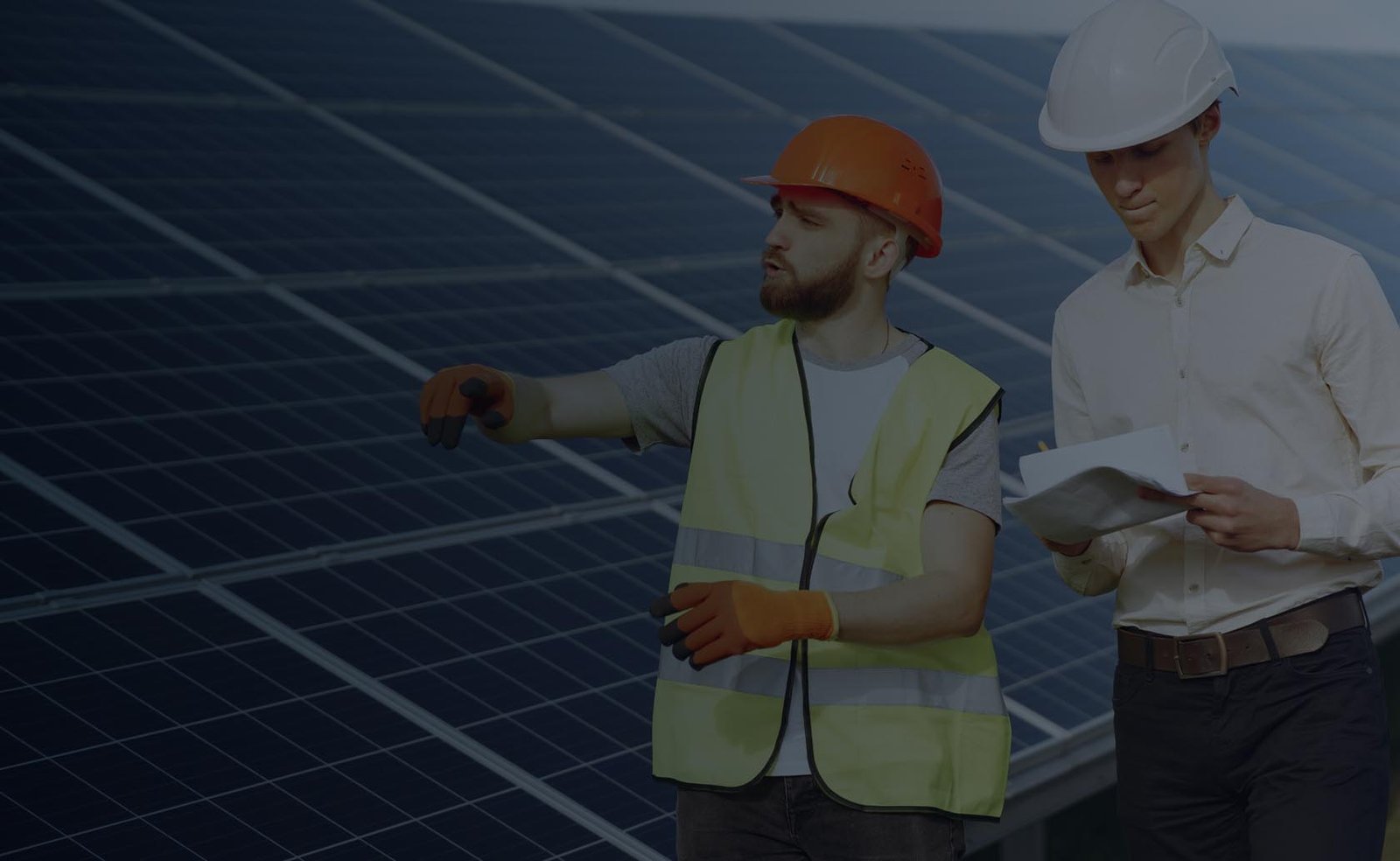 Team members inspecting solar panel installation.